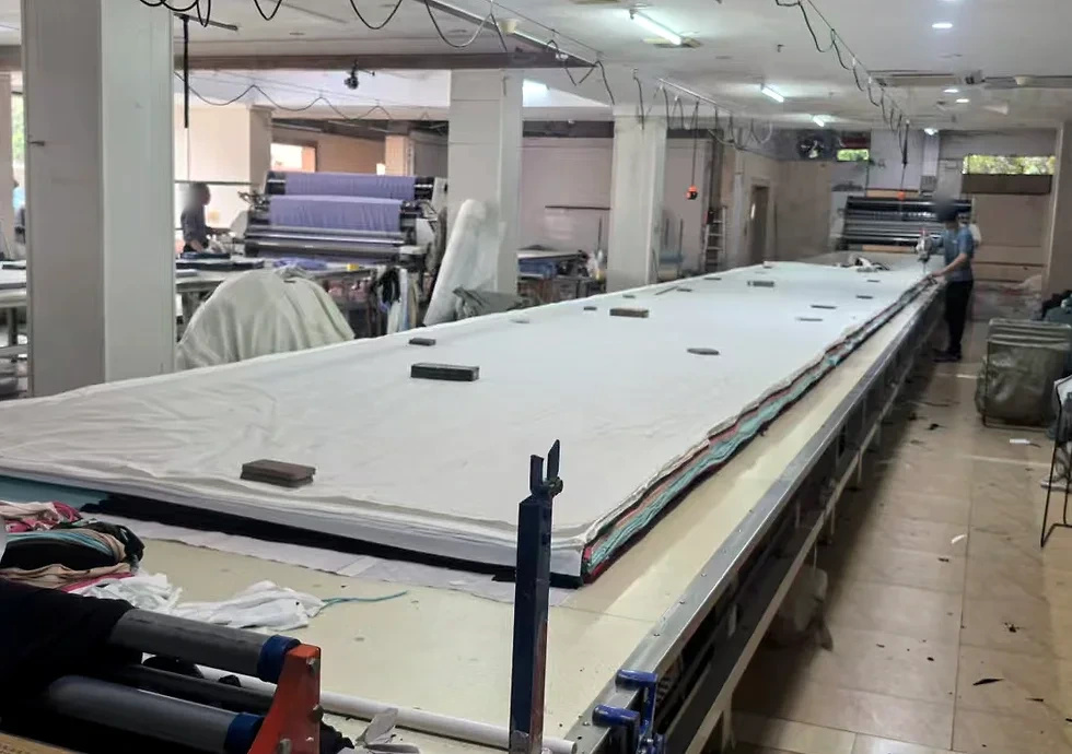 Long cutting table and fabric spreading area inside the factory